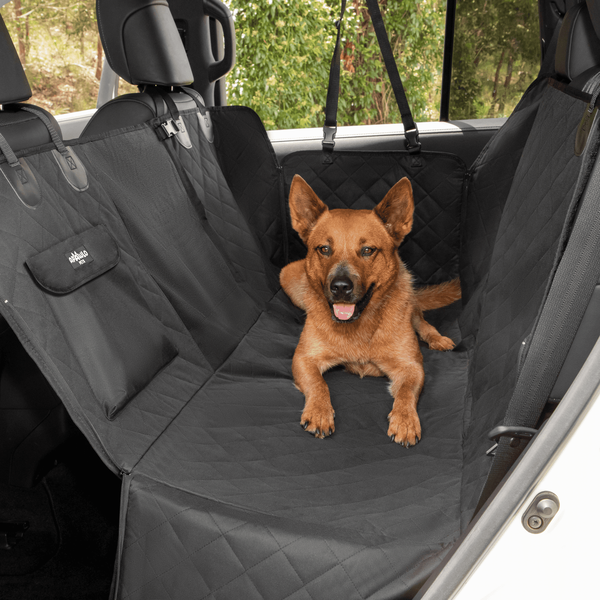 Dog car seat cover installed hammock-style in car backseat, large dog sitting comfortably #drive-configuration_left-hand-drive